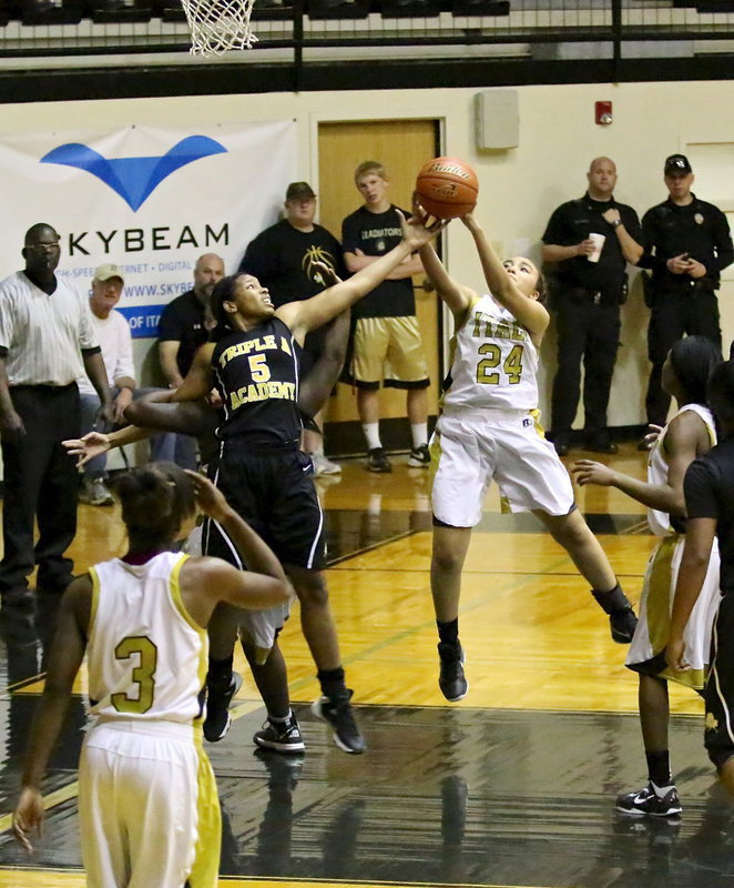 Image: Vanessa Cantu(24) grabs a rebound as Taleyia Wilson(22) stays locked onto a Lady Stallion.