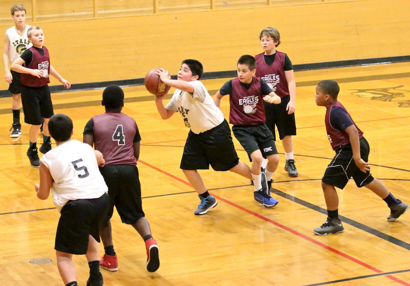 Image: IYAA’s Andrew Celis(1) takes a shot despite being entangled with a Hillsboro defender.