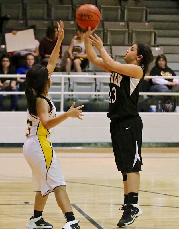 Image: Ashlyn Jacinto(13) puts up the shot over a Wampus Cat paw.