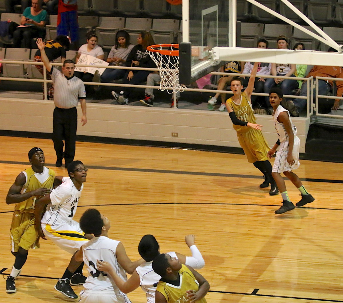Image: Joshua Cryer(20) attempts a 3-pointer from the corner with teammates Khumbo Bailey(13) and Kenneth Norwood, Jr. in position to rebound.