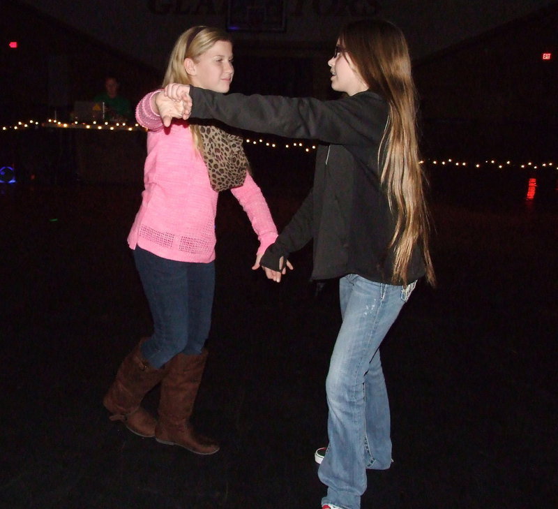 Image: Karson Holley and Karley Nelson practice some dance moves.