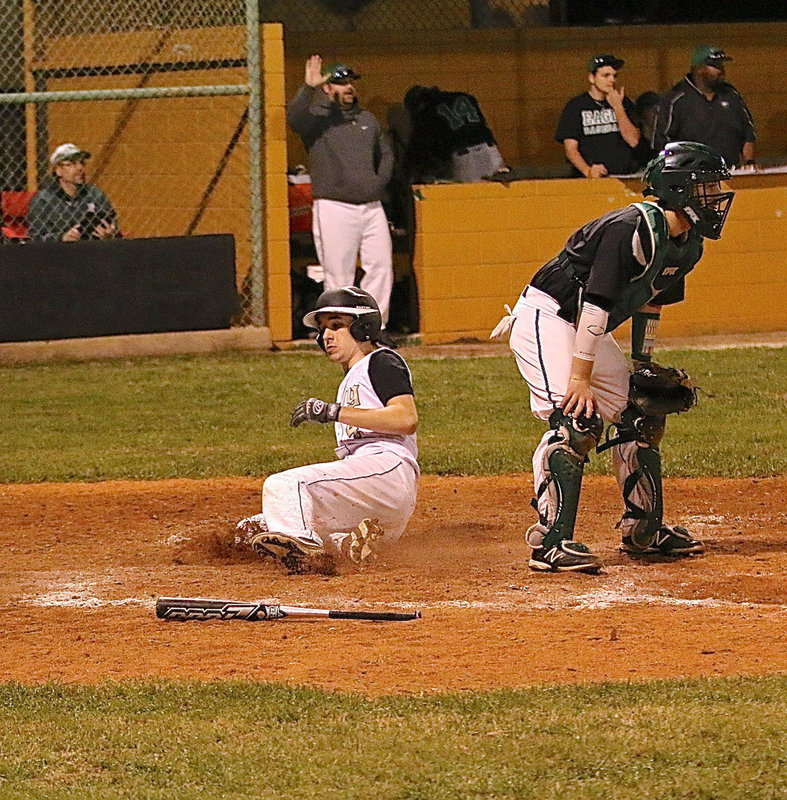 Image: Ryan Connor(4) slides into home to make the score 10-7 with Italy about to load the bases.