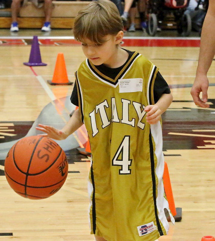 Image: As a rookie competing in the games, Italy’s Frank South(14) was more like a seasoned pro as he quickly mastered dribbling down and back between cones in a timed event.
