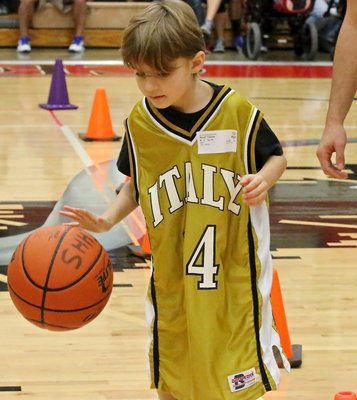Image: As a rookie competing in the games, Italy’s Frank South(14) was more like a seasoned pro as he quickly mastered dribbling down and back between cones in a timed event.