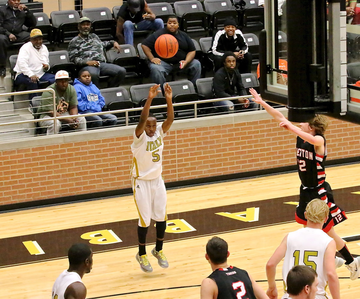 Image: Gladiator Kevin Johnson(5) tries his luck with a 3-pointer from the corner wing.