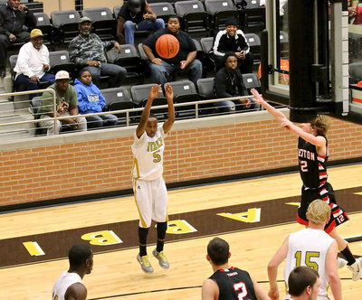 Image: Gladiator Kevin Johnson(5) tries his luck with a 3-pointer from the corner wing.