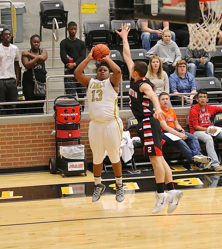 Image: Gladiator Darol Mayberry(13) tries a 3-pointer from the corner with a Tiger closing in.