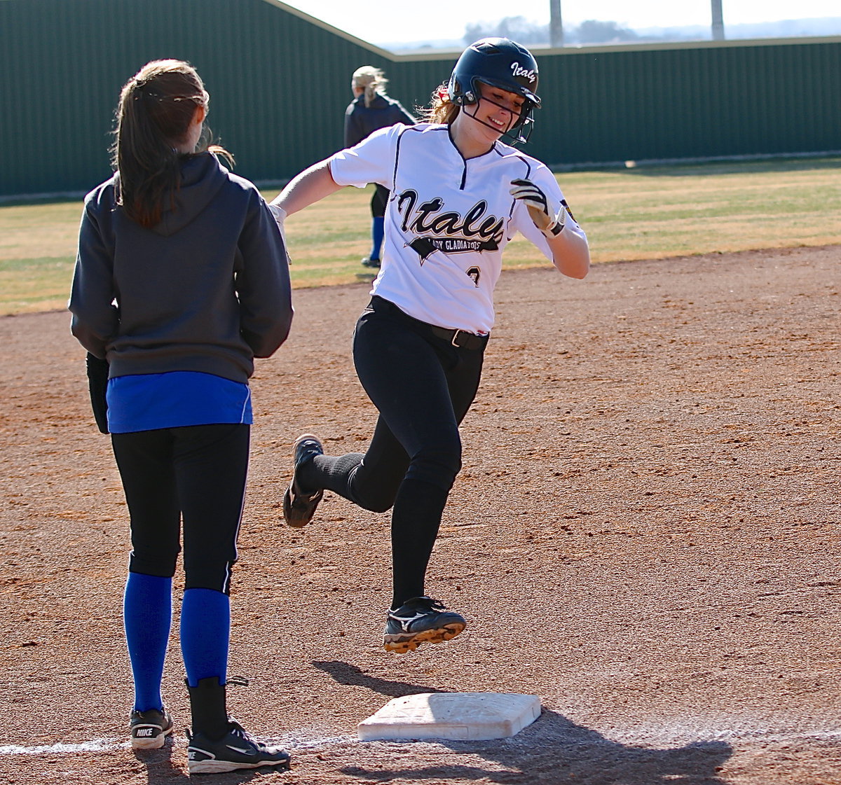 Image: Madison Washington(2) is all smiles as she rounds third during her home run hit.