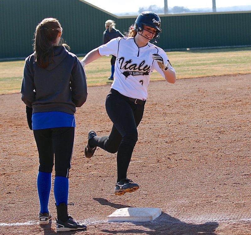 Image: Madison Washington(2) is all smiles as she rounds third during her home run hit.