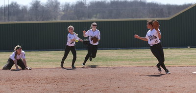 Image: Teamwork and hustle! Left fielder Britney Chambers(4) and center fielder Kelsey Nelson(14) backup the infield with Chambers passing to April Lusk(16) to get a force out at second-base.