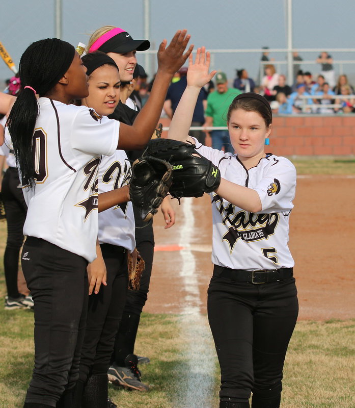 Image: Tara Wallis(5) is wished good luck by her teammates before the Lady Gladiators take on Lake Worth during their final game of the Hillsboro Invitational. Italy went on to defeat Lake Worth 11-1.