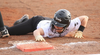 Image: Bailey Eubank(1) gets back to the first-base bag safely.