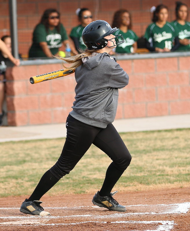 Image: Italy’s Kelsey Nelson(14) blasts one into the outfield.