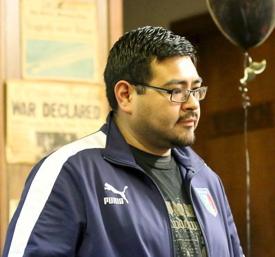 Image: Band director Jesus Perez seems to be fixated on a plate of spaghetti.
