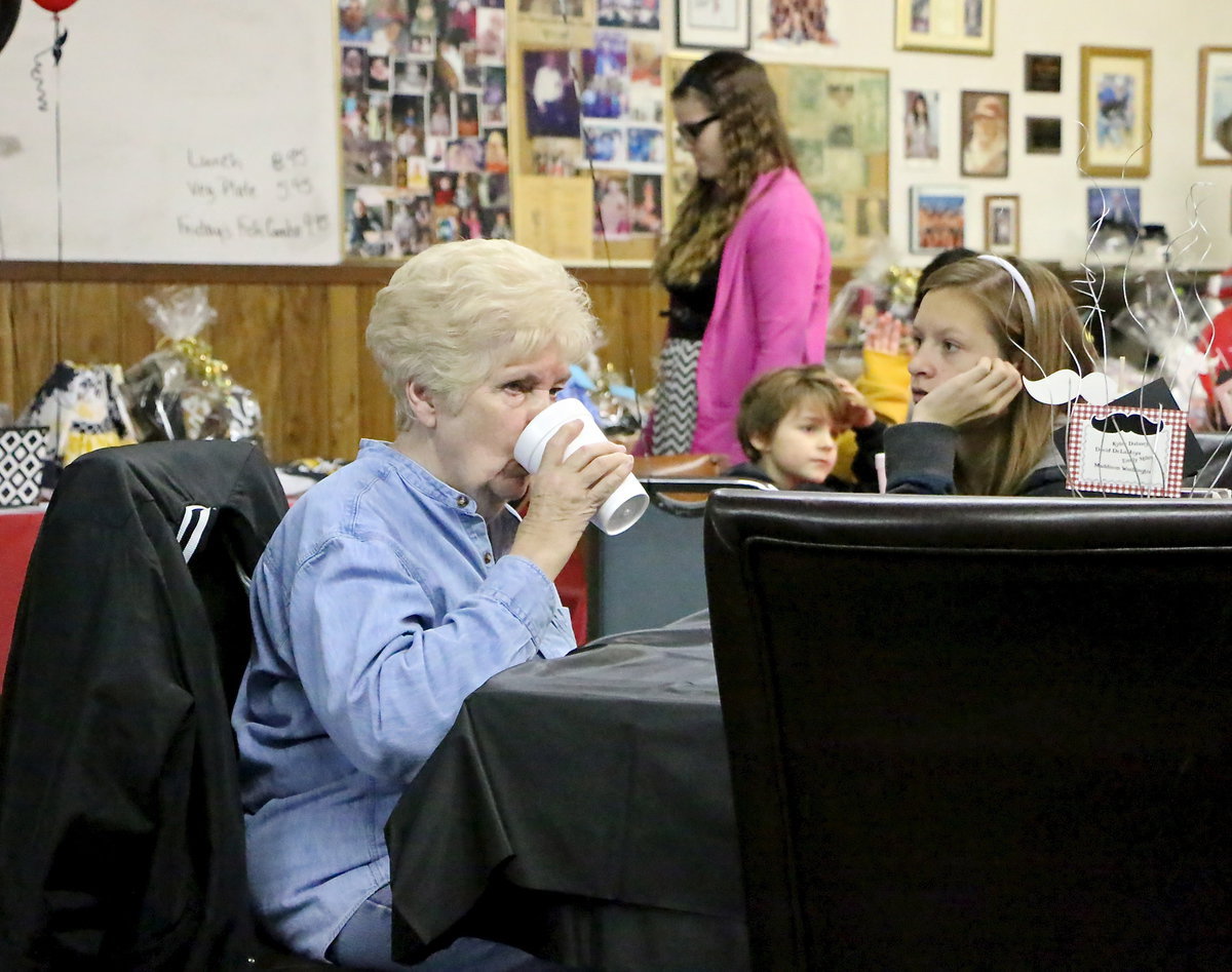 Image: Birdie Bell washes down her spaghetti dinner.