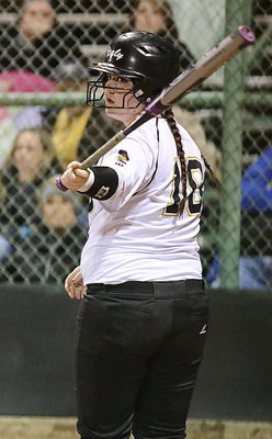 Image: Paige Westbrook(18) checks with head coach Wayne Rowe at third-base before stepping into the batter’s box.