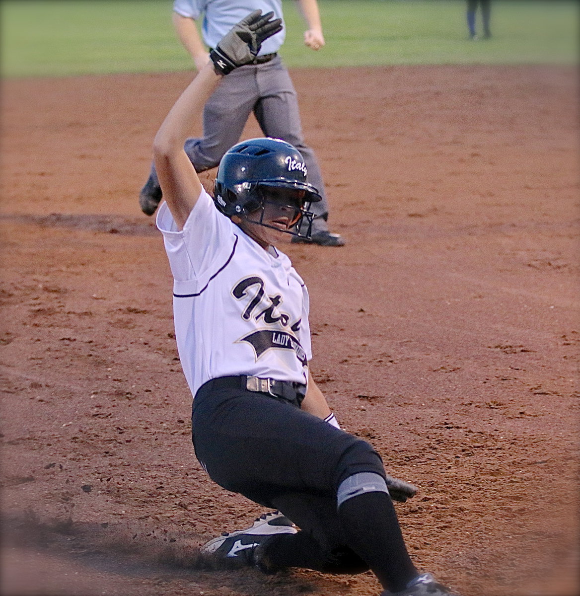 Image: April Lusk(18) successfully reaches third-base.