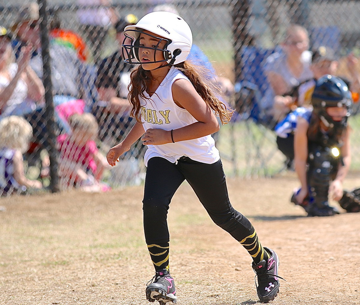 Image: Justice Shelby scores for Italy during the Coach Pitch Girls game.