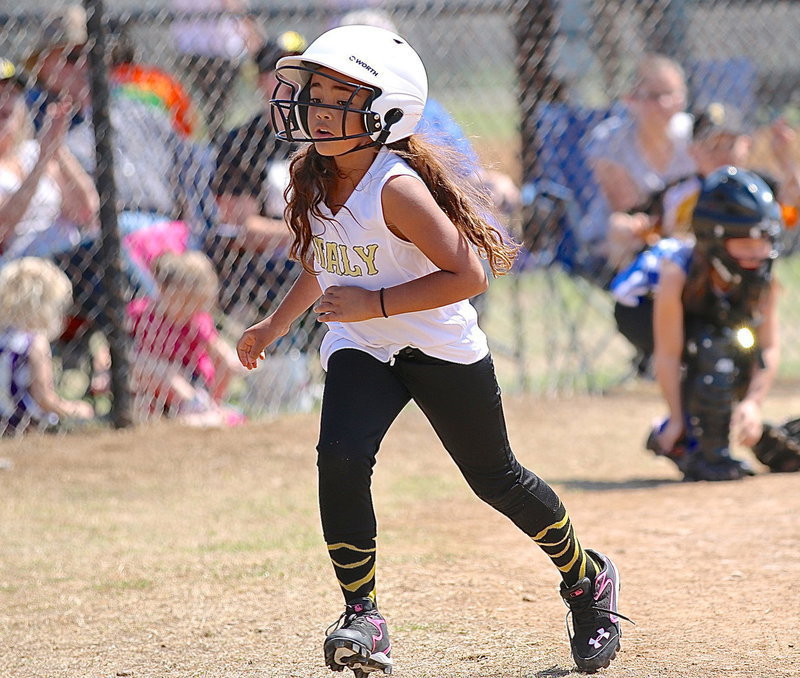 Image: Justice Shelby scores for Italy during the Coach Pitch Girls game.