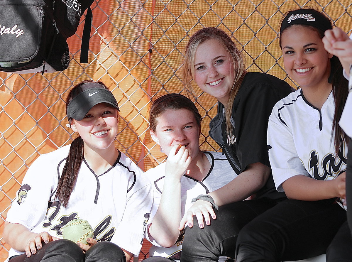 Image: Bailey Eubank, Tara Wallis, Kelsey Nelson and Ashlyn Jacinto are dug in inside the dugout.
