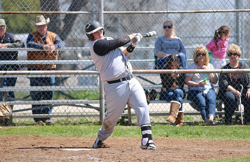Image: Italy’s John Byers(21) vies for some of the action at the plate with a sharp swing at an Eagle pitch.