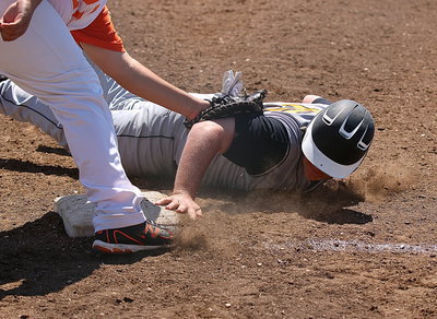 Image: Tyler Vencill(16) slides back safely to the first-base bag after getting on base.