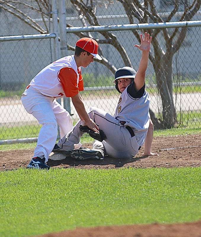 Image: Tyler Anderson(9) calls for a timeout after beating the throw to third-base.