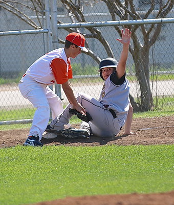 Image: Tyler Anderson(9) calls for a timeout after beating the throw to third-base.