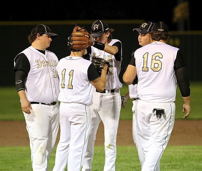 Image: Infielders John Byers(18), Ty Windham(12), Zain Byers(5) and Kevin Roldan(16) try to keep Tyler Anderson(11) in the zone.