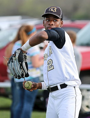 Image: Senior Eric Carson(2) warms up behind Italy’s dugout.