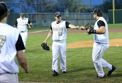 Image: Tyler Anderson(11) gets plenty of support from first-baseman Kevin Roldan(16) and the rest of his teammates with Anderson hanging in there against the Bulldogs.