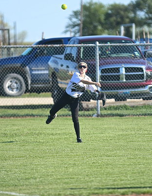 Image: Italy’s Britney Chambers(4) hurries a ball in from left field during a critical part of the game.