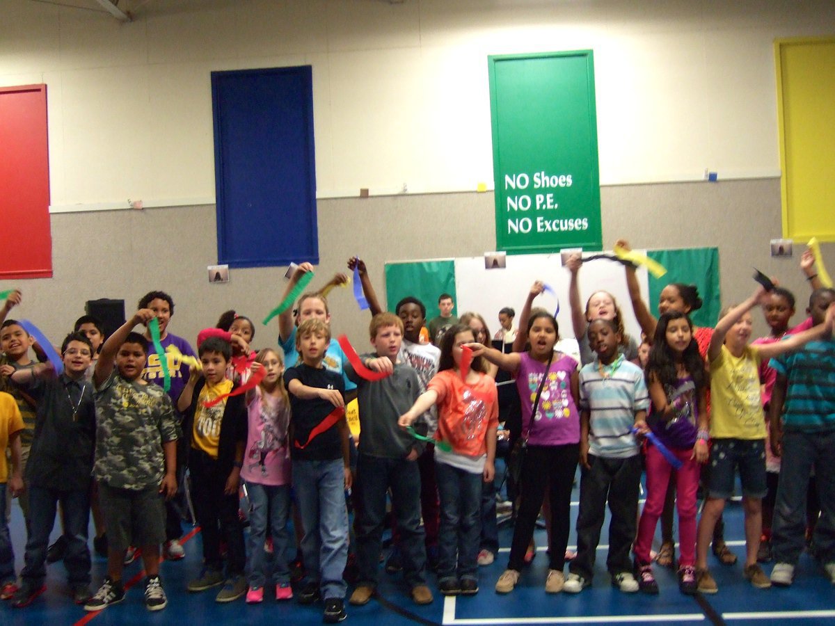 Image: Fourth graders singing “We are the Champions” as they waved their ribbons.