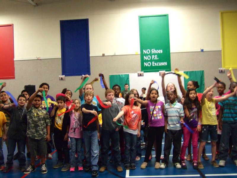 Image: Fourth graders singing “We are the Champions” as they waved their ribbons.