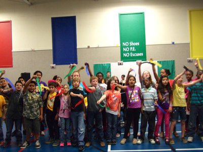 Image: Fourth graders singing “We are the Champions” as they waved their ribbons.