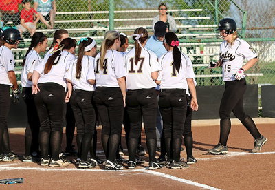 Image: Junior power hitter Jaclynn Lewis(15) records her first home run of the 2014 season with a solo shot over the centerfield wall as her teammates welcome her home.