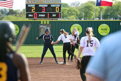 Image: Lady Gladiator shortstop Madison Washington(2) tries to catch an Eagle runner off the second-base bag.