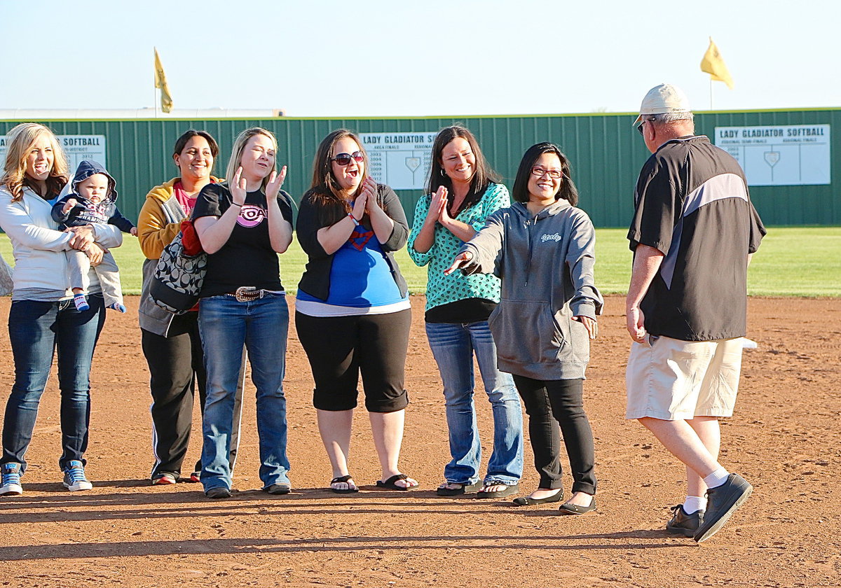 Image: Coach Johnny Jones is greeted by his daughter and his former player, JoAnn Jones-Miller, before being congratulated by more of his former players after having his name unveiled atop the Lady Gladiator scoreboard.