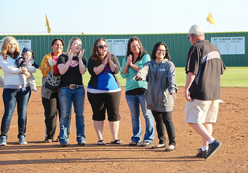 Image: Coach Johnny Jones is greeted by his daughter and his former player, JoAnn Jones-Miller, before being congratulated by more of his former players after having his name unveiled atop the Lady Gladiator scoreboard.