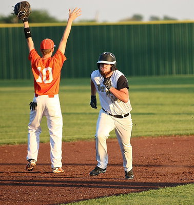Image: Junior Kyle Fortenberry(14) huffs and puffs his way to third-base for the Gladiators.