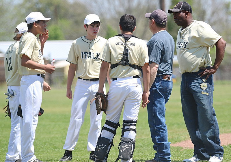 Image: Coaches, Jason Escamilla and Kenneth Norwood, Sr., discuss lineup changes with their squad.
