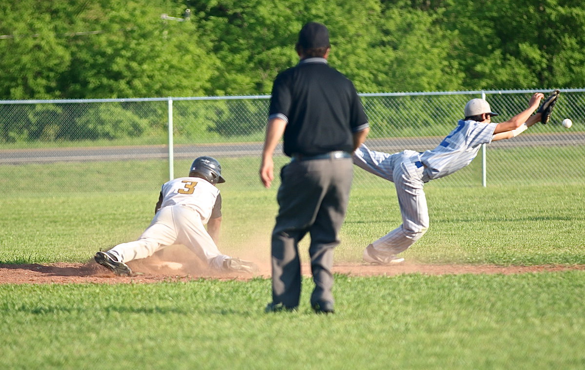 Image: Italy’s Eric Carson(3) slides under the throw to Milford’s Daren Cisneros(12) at second-base and then Carson heads for third on the overthrow.