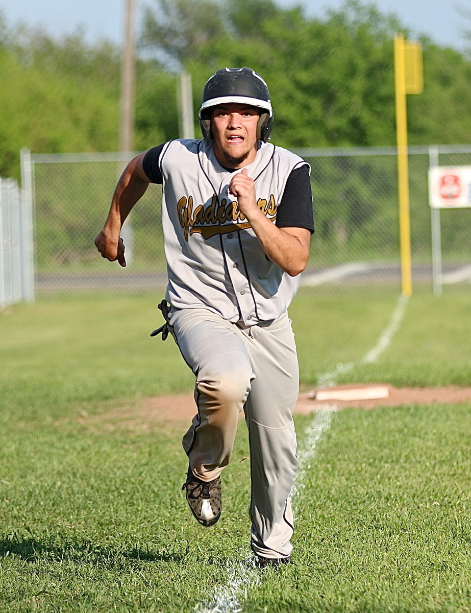 Image: Tyler Anderson(9) was determined to help his Gladiators claim the district championship.