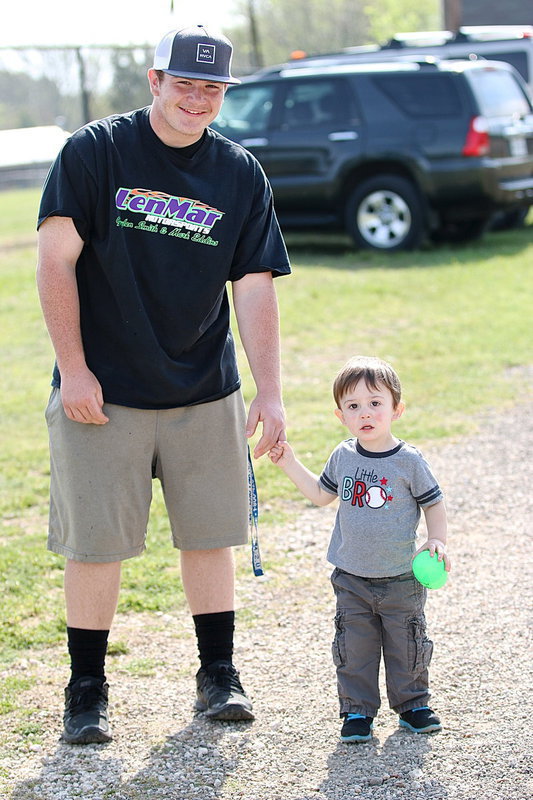 Image: Tyler Vencill escorts the big winner, Bentley Gossett, who found the $25.00 money egg!