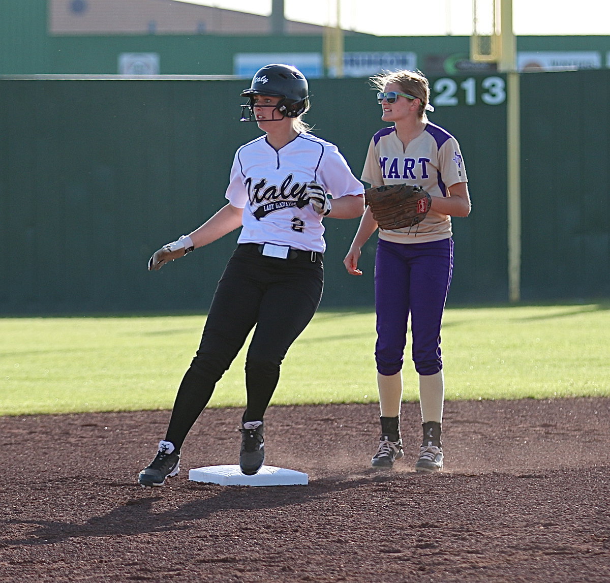 Image: Lady Gladiator Madison Washington(2) turns and looks at second base after her double gives Italy a 1-0 lead.