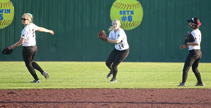 Image: Center fielder Kelsey Nelson(14) covers another ball hit into the outfield with Madison Washington(2) and Bailey Eubank(1) nearby if needed.