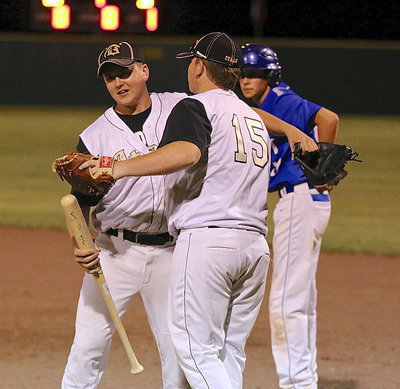 Image: Gladiator senior Bailey Walton(17) is subbed out by junior Tyler Vencill(15) as Vencill presents Walton with an engraved wooden baseball bat signed by all the Italy players and coaches.