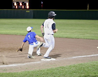 Image: Kyle Fortenberry(14) hits to reach first-base and then heads to second after the overthrow.