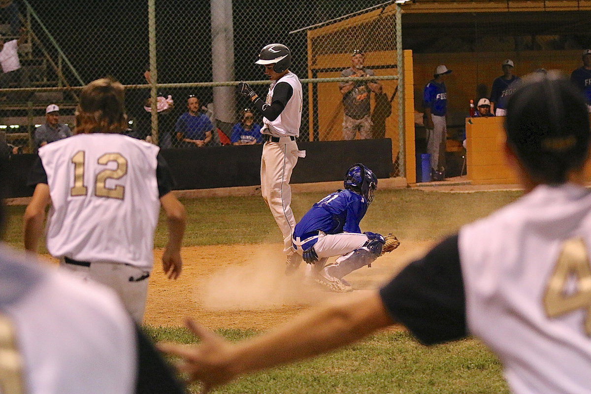 Image: The Gladiator dugout empties as Levi McBride(1) hops onto a home plate after turning a deep hit into centerfield into an inside-the-park home run.