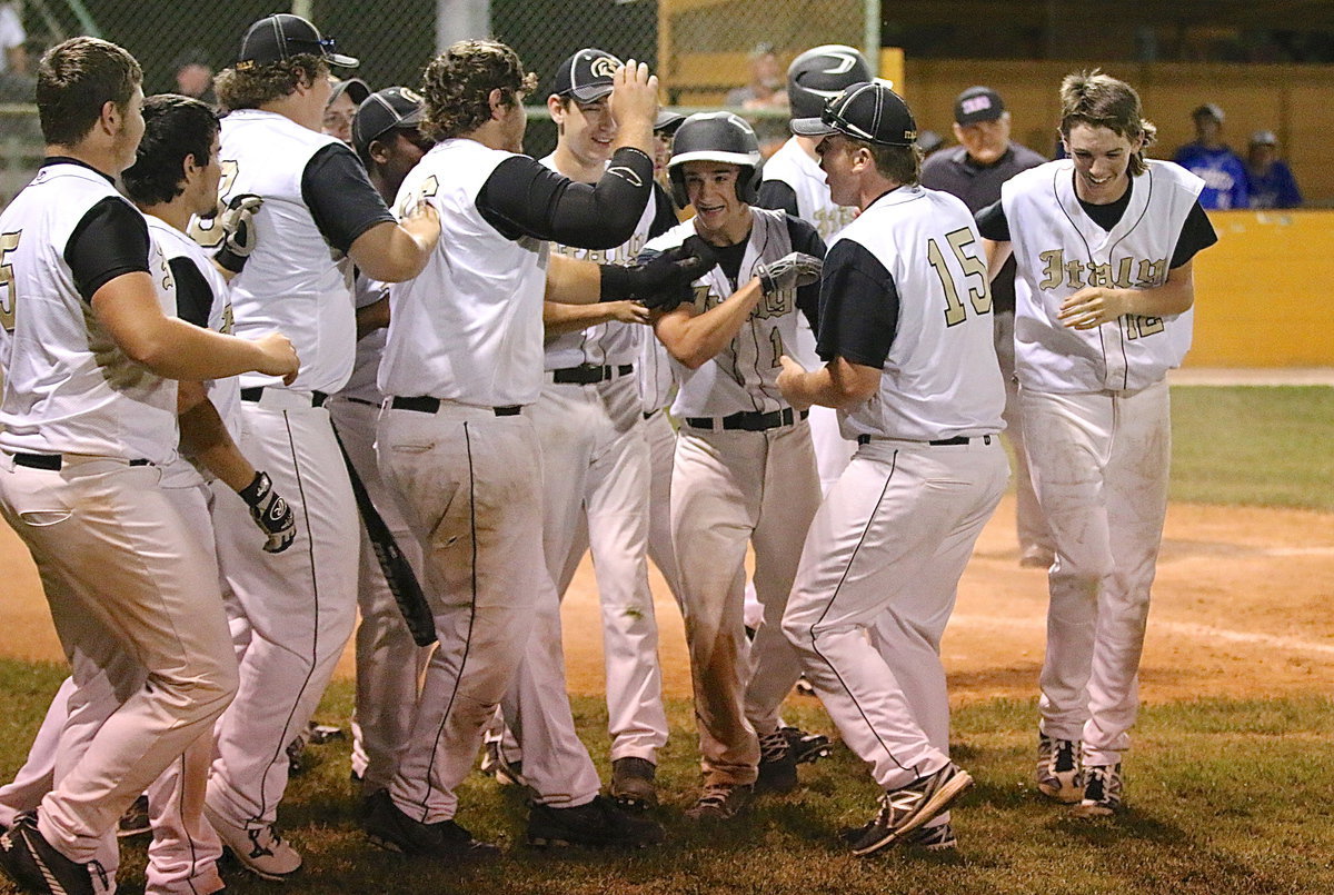 Image: Levi McBride(1) is congratulated by his Gladiator teammates after the sophomore recorded his second homer of the season.